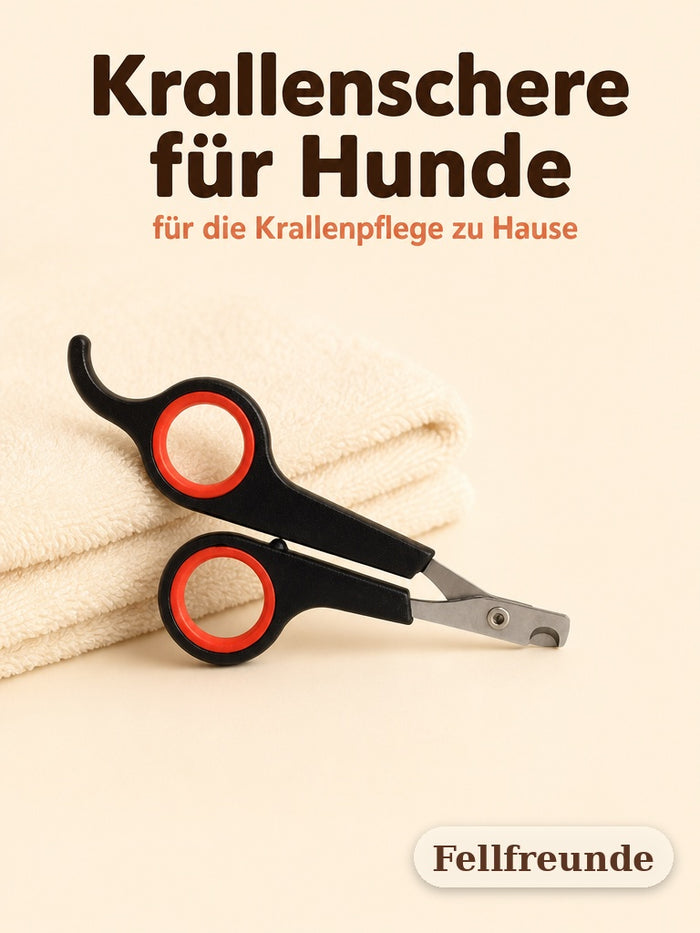 Krallenschere für Hunde mit schwarzen Griffen und roten Ringen auf cremefarbenem Handtuch